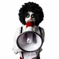 Foto gratuita orologio dell'annata della holding del clown dell'assassino