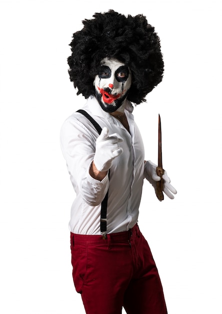 Killer clown with knife shouting