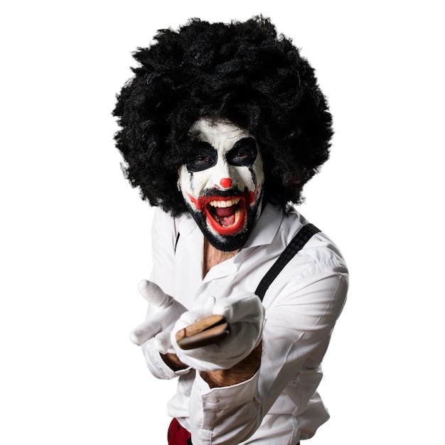 Free photo killer clown with knife shouting