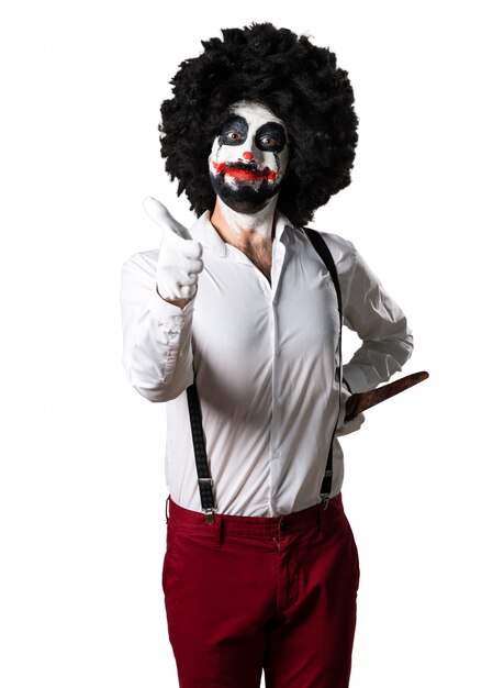 Killer clown with knife with thumb up