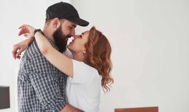 Kissing each other. Happy couple together in their new house. Conception of moving