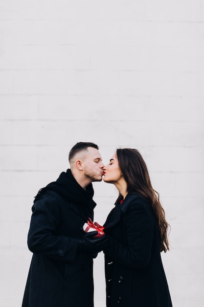 Kissing elegant couple on white