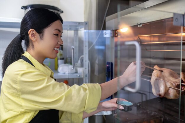 At the kitchen. Asian young girl working in the kitchen and preparing food