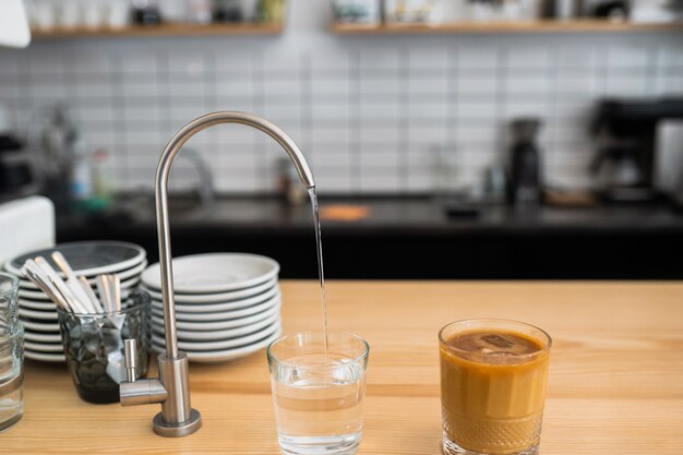 A kitchen countertop and a sink with dishes.