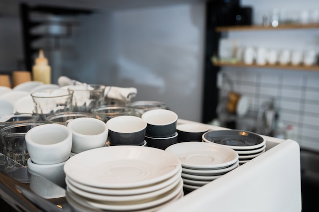 A kitchen countertop and a sink with dishes