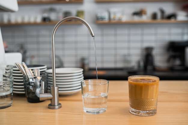 A kitchen countertop and a sink with dishes.