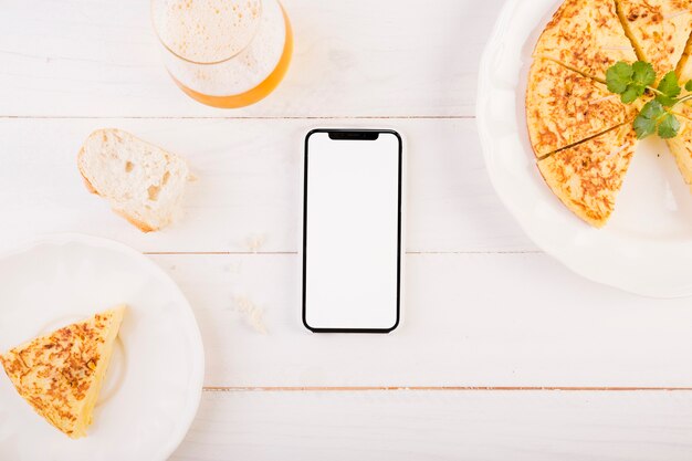 Kitchen desktop with pie and smartphone
