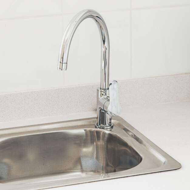 Kitchen faucet with near a white wall