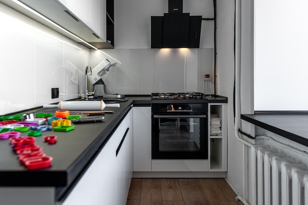 Kitchen interior with cookie cutters cooking cookies