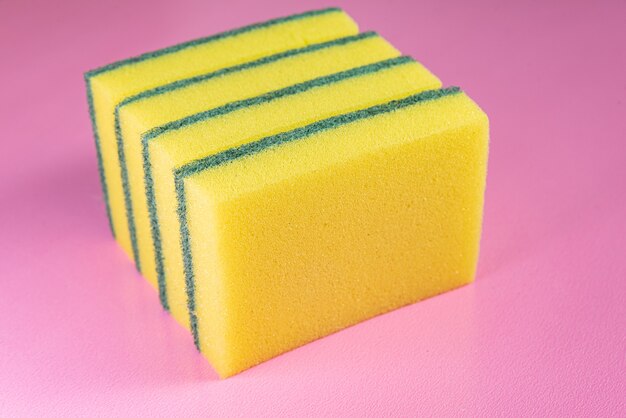 Kitchen sponge on the pink background