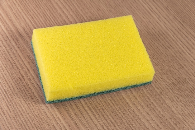 Kitchen sponge on the wooden background