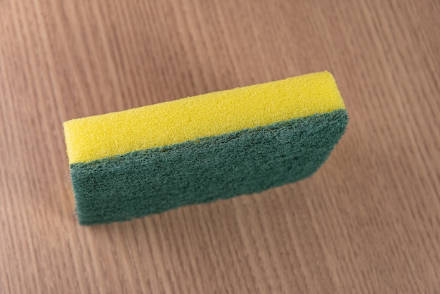 Kitchen sponge on the wooden background