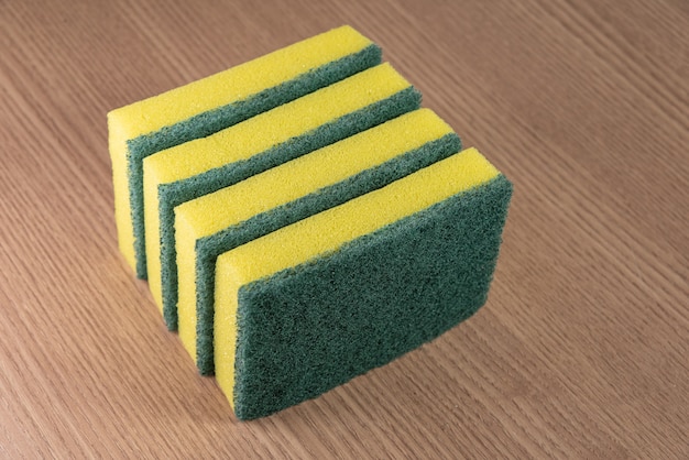 Kitchen sponge on the wooden background