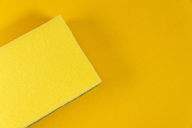 Kitchen sponge on the yellow background