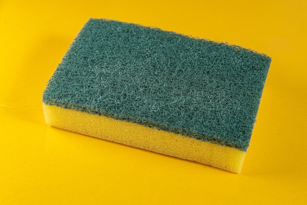 Kitchen sponge on the yellow background