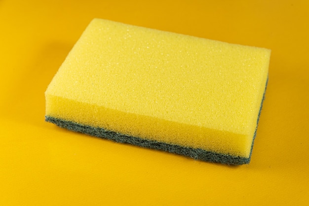 Kitchen sponge on the yellow background