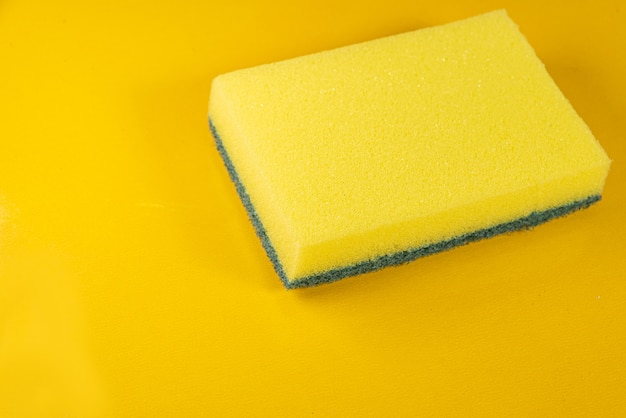 Kitchen sponge on the yellow background