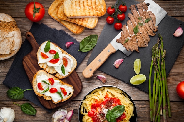 Kitchen table with ready dishes and ingredients