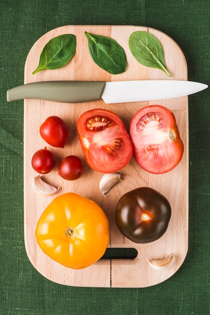 ホウレンソウ、トマトの近くに横たわるナイフ