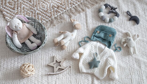 Knitted children's clothing on a light background with accessories