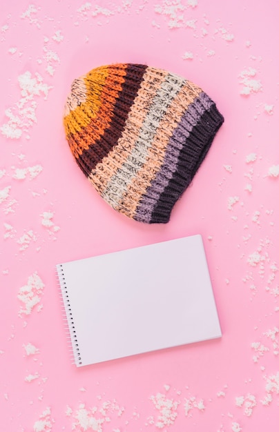 Knitted hat near notebook 