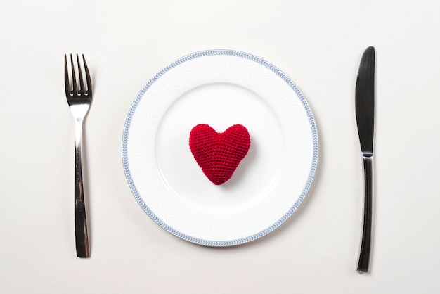 Knitted heart on plate