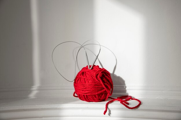 Knitting concept with red yarn