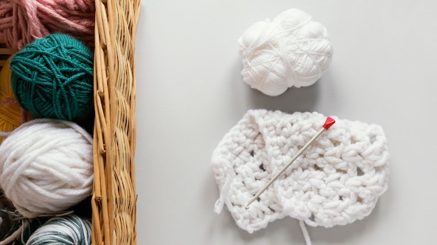 Knitting needles and wool in basket