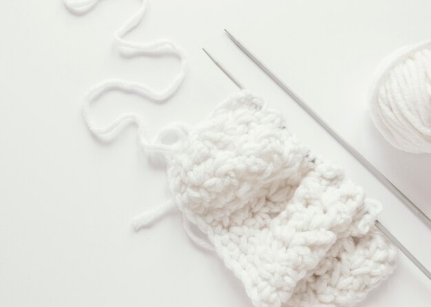 Knitting needles and wool on desk