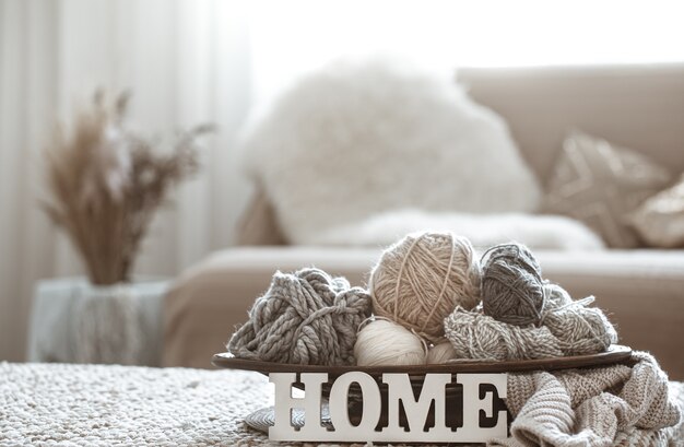 Knitting threads on the table and Home wooden letters