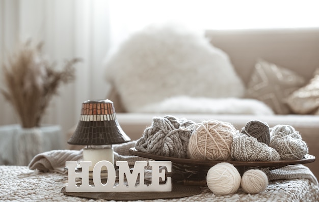 Free photo knitting threads on the table and home wooden letters