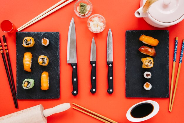 Knives among sushi and condiments