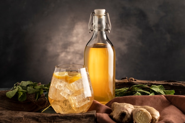 Kombucha bottle and glass arrangement still life