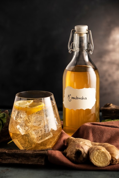 Kombucha bottle and glass arrangement