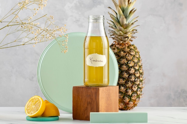 Free photo kombucha bottle and pineapple