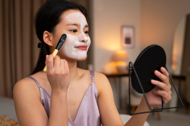 Free photo korean woman doing skincare