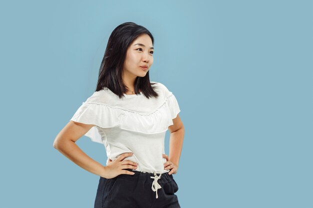 Korean young woman's half-length portrait on blue background