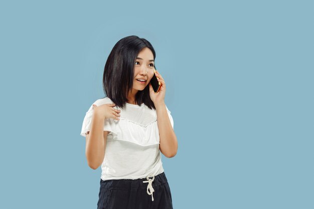 Korean young woman's half-length portrait on blue background