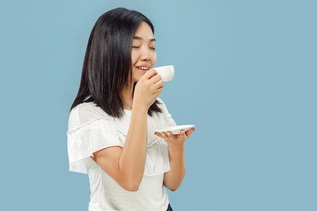 Korean young woman's half-length portrait on blue background