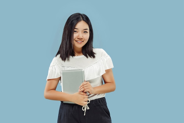 Free photo korean young woman's half-length portrait on blue background