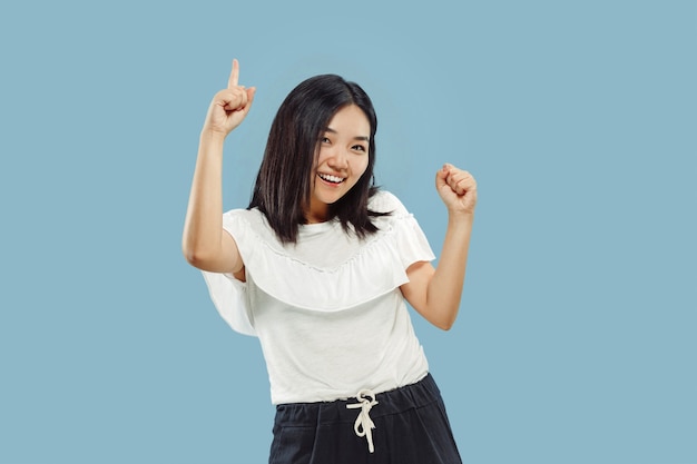 Korean young woman's half-length portrait on blue studio