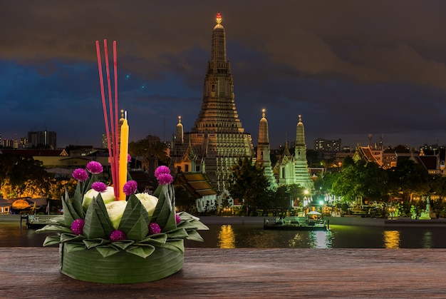 Krathong festival on wood table with clipping path.at wat arun background.