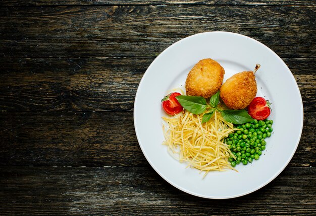 Kyev cutlets with bone, green beans and noodles