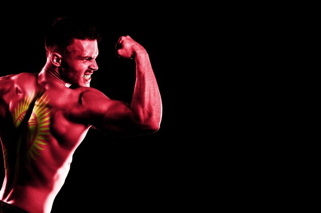 Kyrgyzstan flag on handsome young muscular man black background