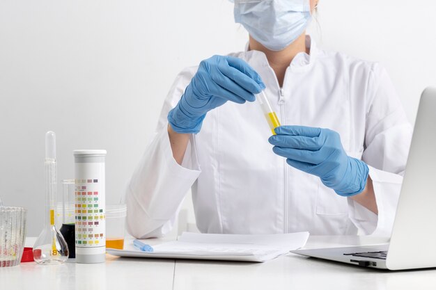 Lab doctor performing medical exam of urine