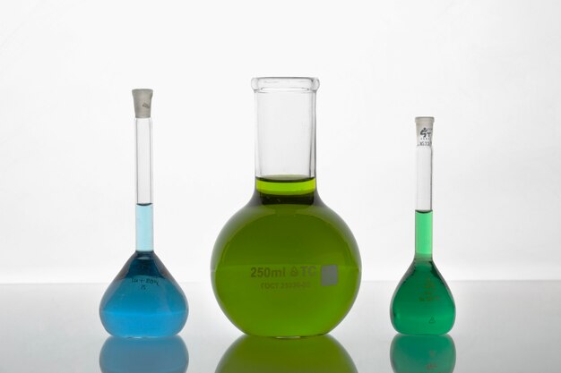 Lab glassware assortment with colorful liquids still life