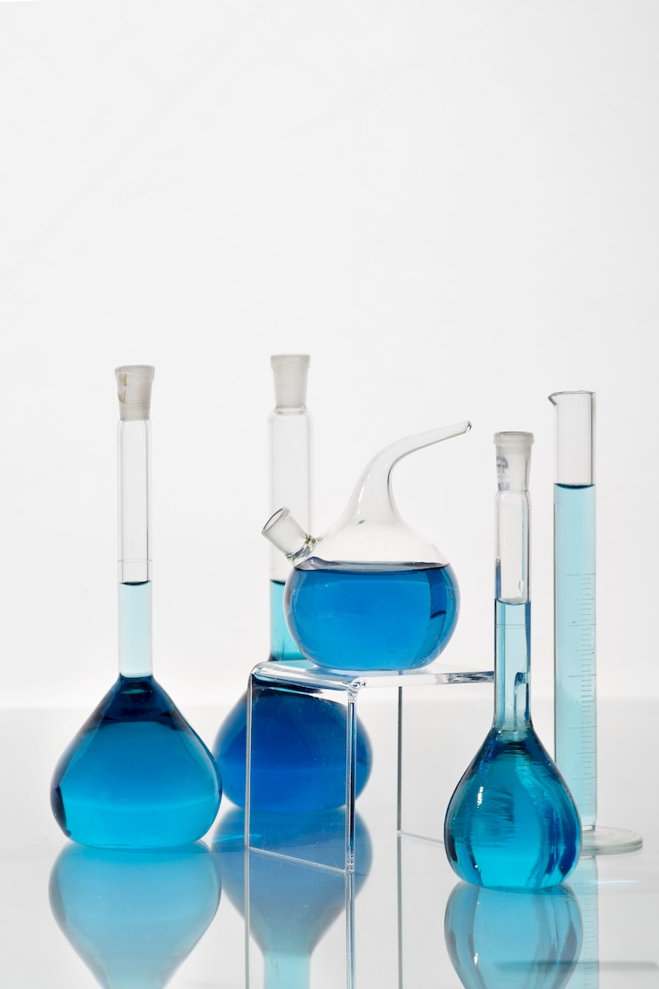Free Photo lab glassware containing blue liquid arrangement