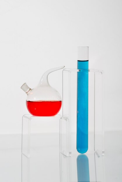 Lab glassware containing blue and red liquids