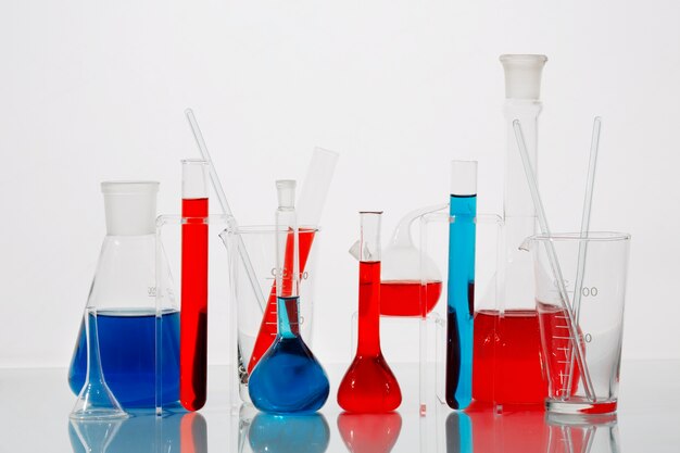 Lab glassware containing red and blue liquid