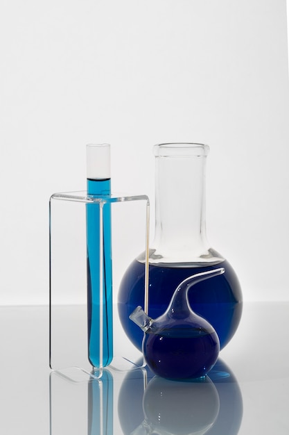 Free photo lab glassware with blue liquid arrangement